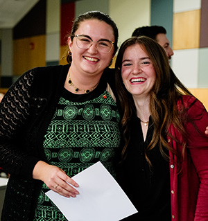 Marian Pope celebrates with Lambda Pi Eta secretary Ruby Stedman.