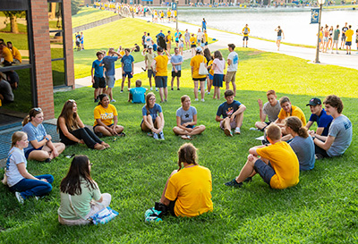 A group of new freshman at Cedarville University get to know on another on the university lawn.