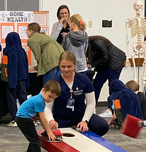 Healthcare students interact with area children at the on-campus health fair.