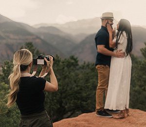 Cara Brethauer photographing a couple in the Colorado mountains.