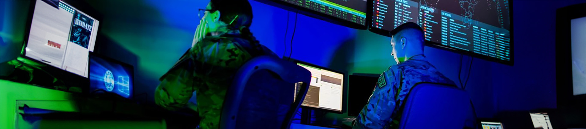 Soldiers work at computer terminals to maintain national defense.
