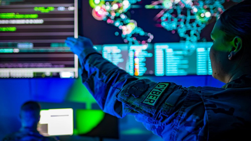 Soldiers work at computer terminals to maintain national defense.