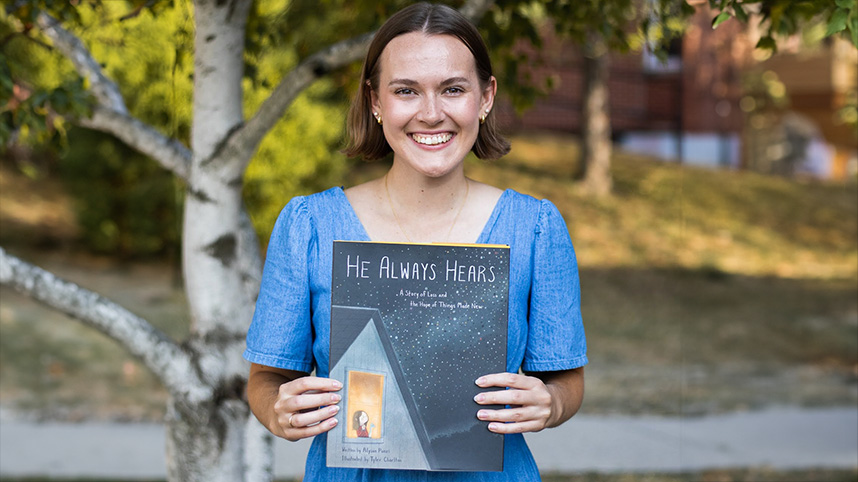 Alyson Punzi holds her award winning children's book, "He Always Hears."