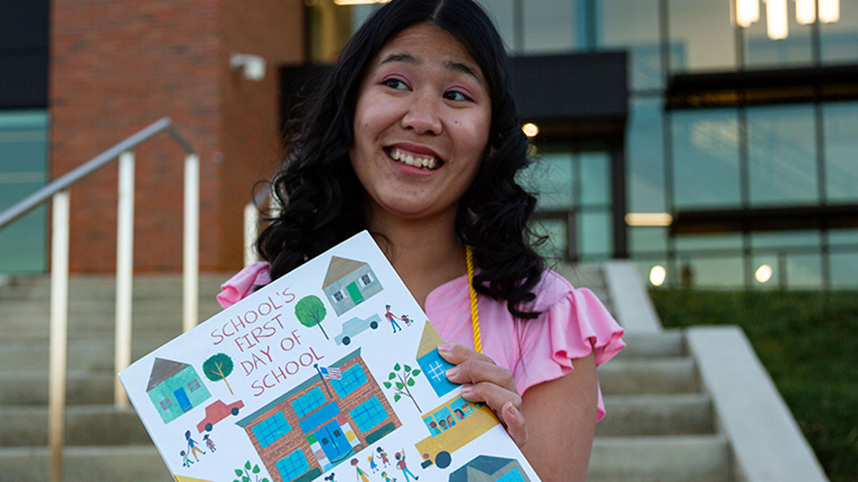 Luckaupt holding a children's book.