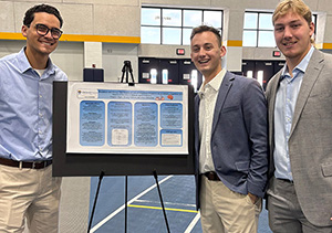 Clay Dyer, Brady Gilbert and Matthew Schelebo with their breakfast research display board.