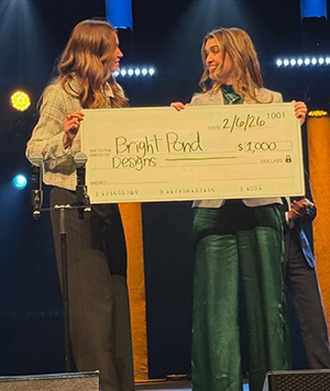 Pitch winner, Jenna Stout receives an oversized check for her Brightpond project.