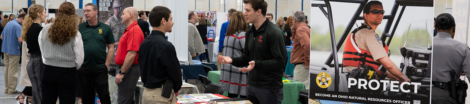 Students talk with law enforcement representatives at the Cedarville University career fair.