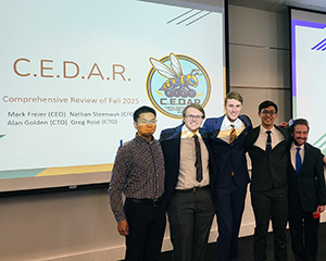 A team of five young men who built the CEDAR tour guide robot.