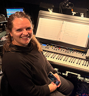 Dani Lee Hutch at the orchestra pit podium for