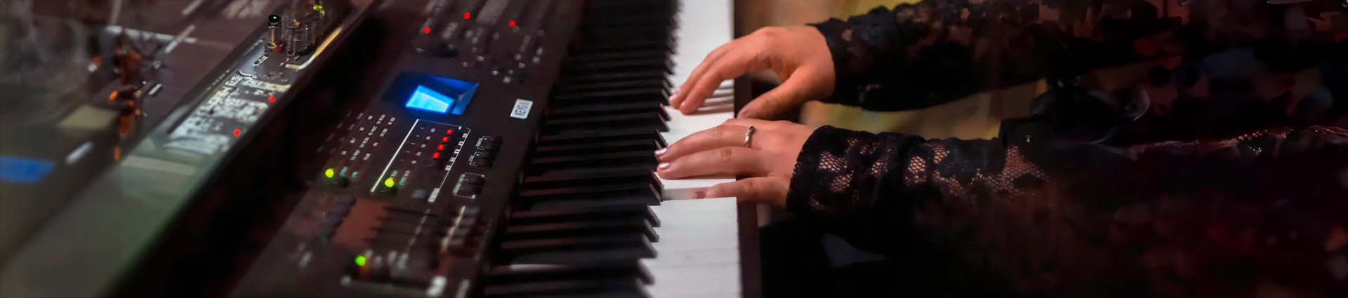 Hands playing a keyboard.