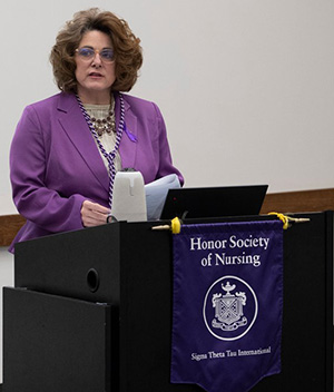 Dr. Michele Dodds speaking at Sigma Theta Tau induction ceremony.
