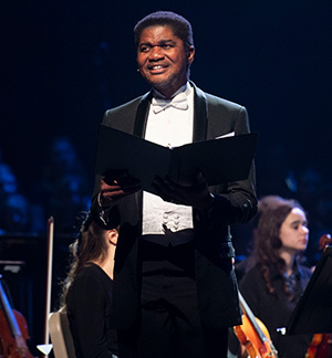 Dr. Lou Lilite in a tuxedo sings at Cedarville's Christmas concert.