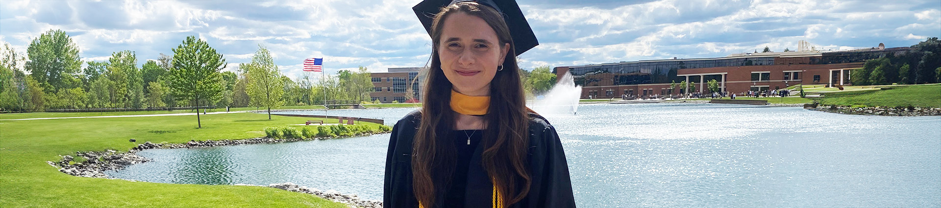 Erin Mitchell in cap and gown by Cedar Lake.