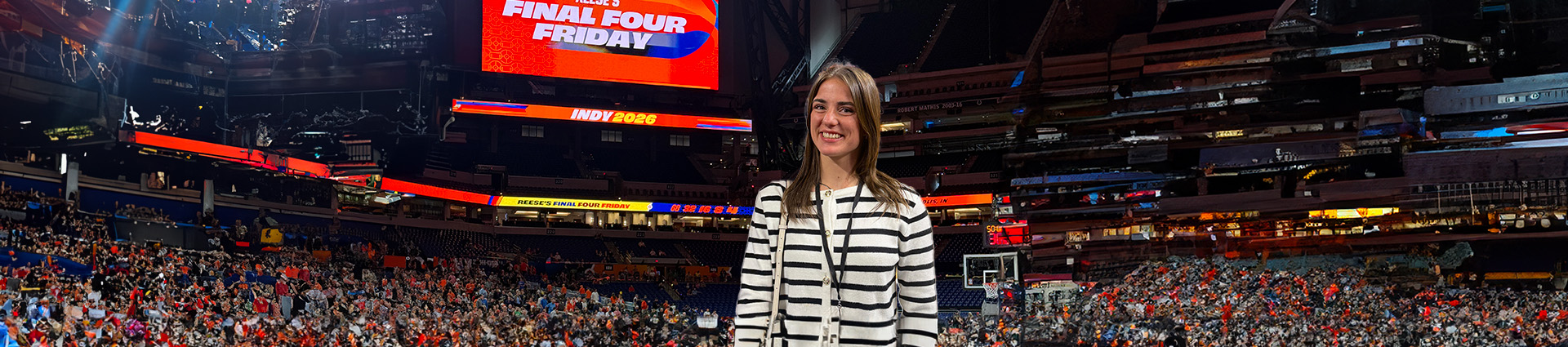 Emily Tuttle in a crowded basketball arena.