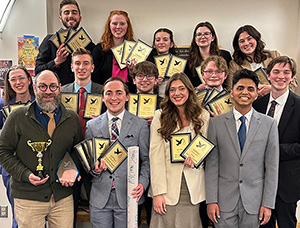 The Cedarville University forensics team poses for a photo with their awards.