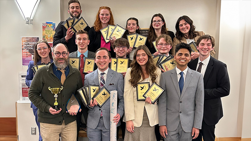 The Cedarville University forensics team poses for a photo with their awards.