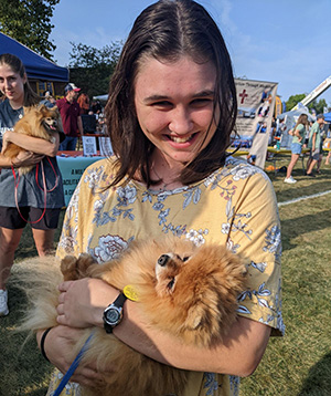Grace Maxwell holding a puppy.