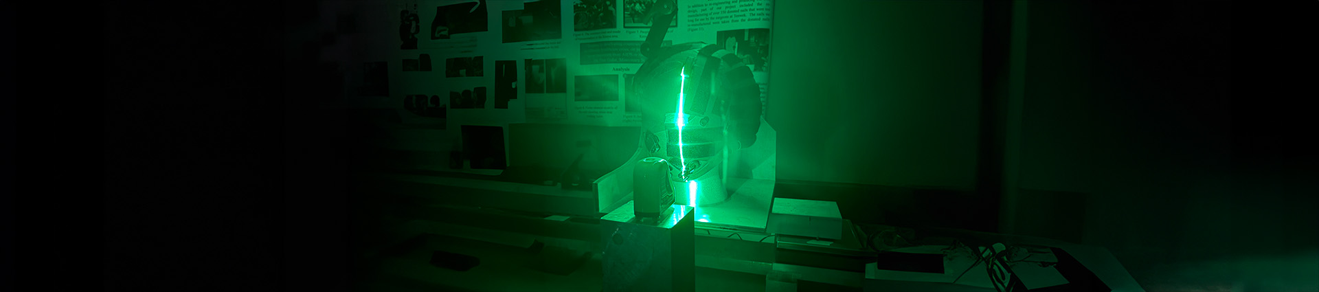 Helmet glowing green as it is undergoing laser testing.
