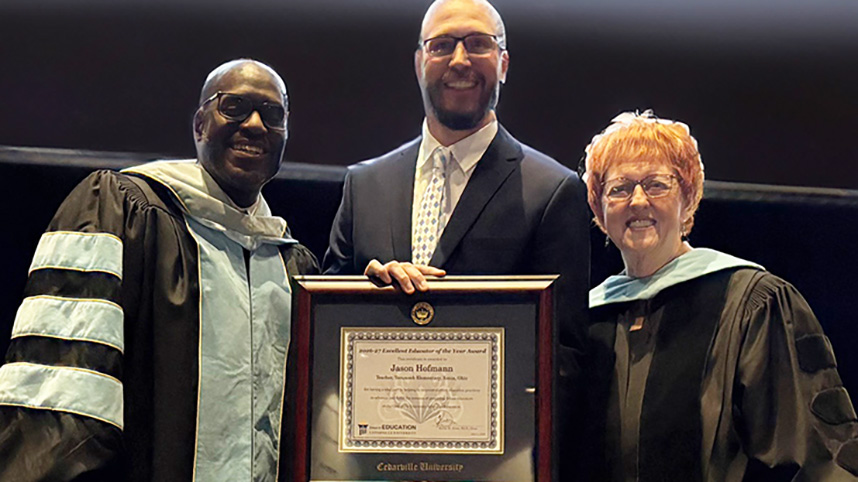 Jason Hofmann receives Excellent Educator of the Year award from Dr. Kevin Jones and Dr. Brenda MacKay.