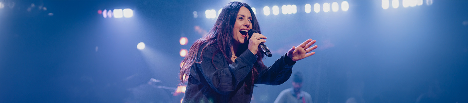 Hope Darst singing with lights and fog.