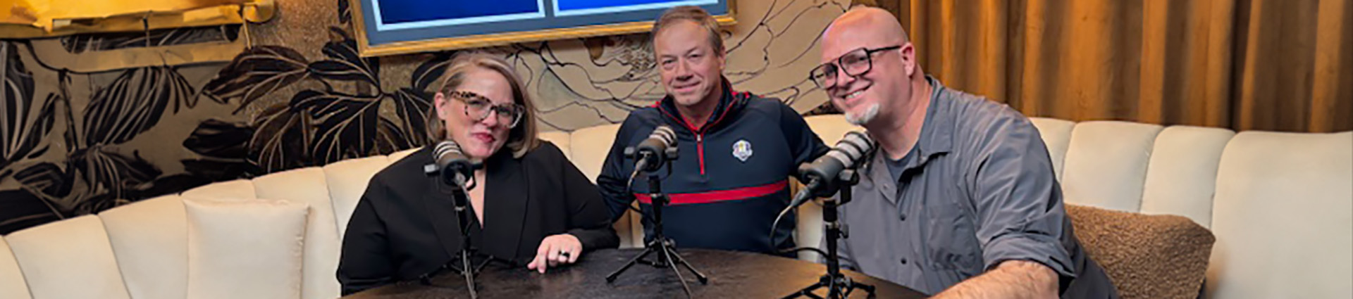 Mandy Young, Jim Houser, and Steve Shore sit around a table at K-Love studios in Franklin, Tennessee.