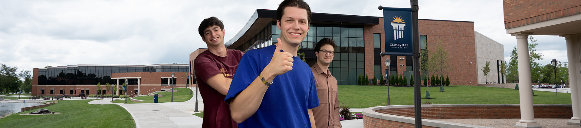 Josh Hochstedler, Will Woods and Aaron Perry in from of the Scharnberg Business and Communication Center.
