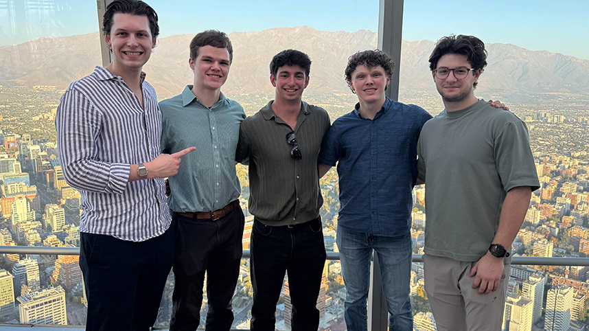 Will Woods, Daniel Ormsbee, Josh Hochstedler, Ben Ormsbee, and Aaron Perry in front of a city skyline in Chile.