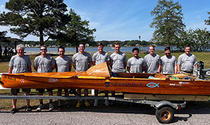 Students and professors with the winning boat.