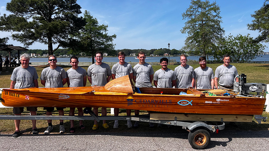 Students and professors with the winning boat.