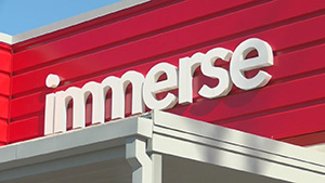 Immerse Arkansas sign on building.