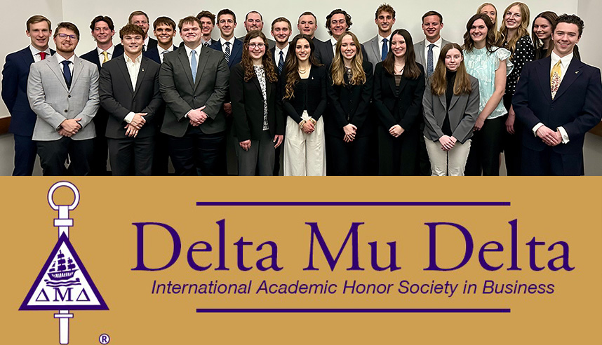 The 25 Cedarville University students inducted into Delta Mu Delta in 2026 above a Delta Mu Delta banner..