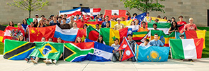 Dozens of international students proudly display their country's flags.