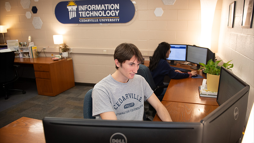 Student at computer in IT management suite at Cedarville University.