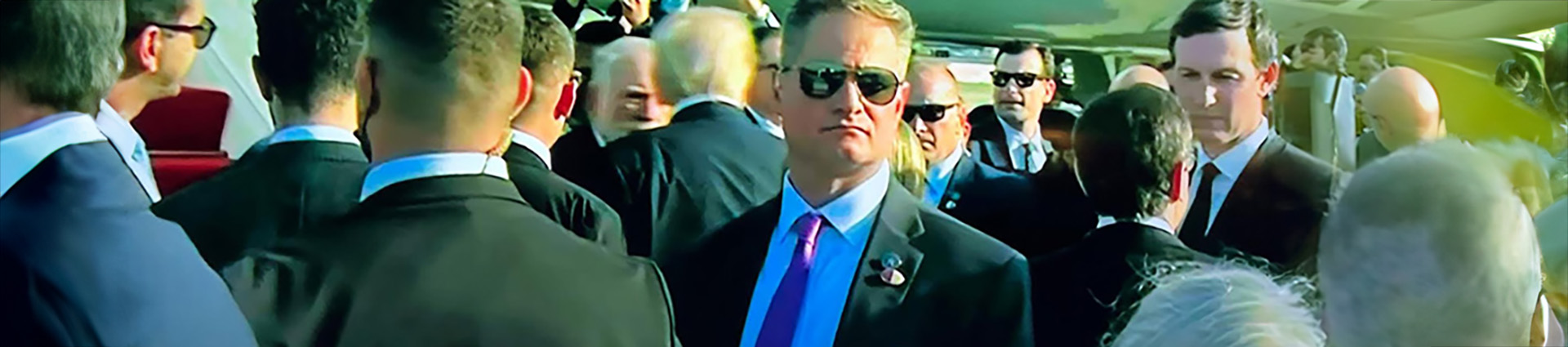 Jeff Rinehart in a crowd near Air Force One with President Trump in background.