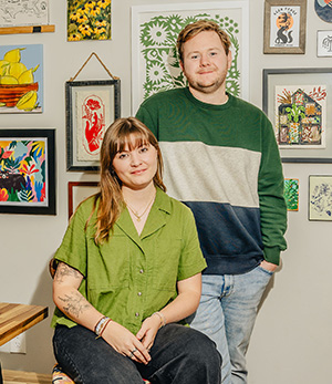 Jesse and Carissa Bowser stand in front of some of their art.