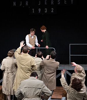 Students portray Charles Lindbergh and his wife as they plead with reporters to help them find their kidnapped child.