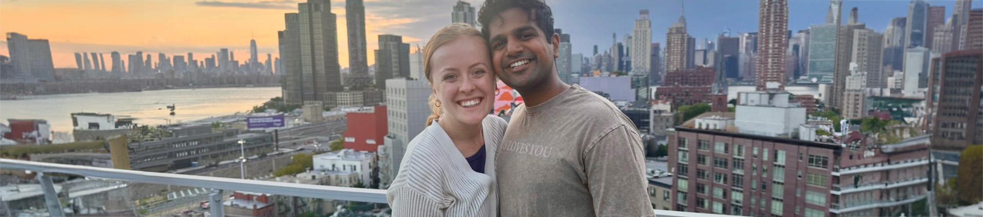 Rufus and Sarah Mathew with the New York skyline behind them.