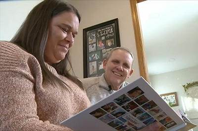 Merav and Dean Maxwell look through a photo album.