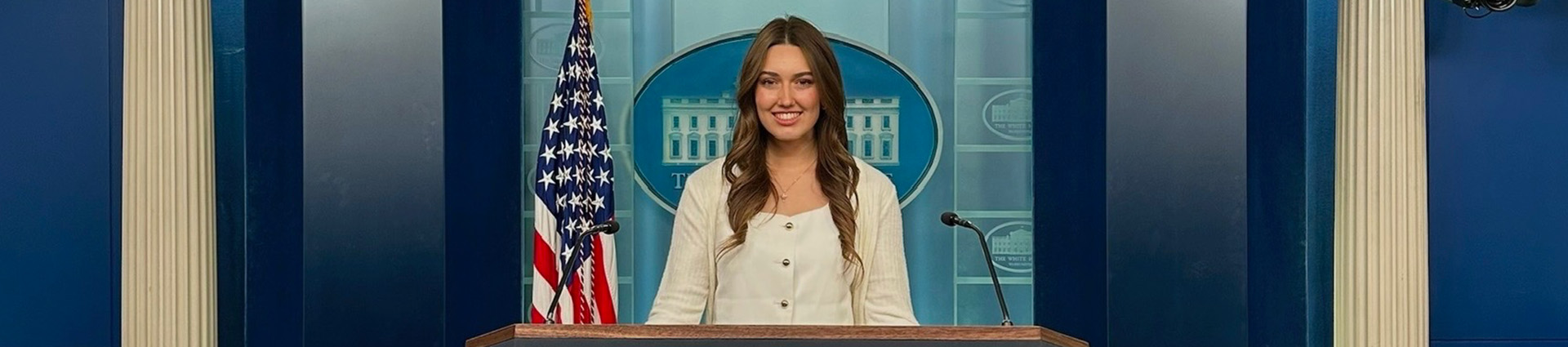 Paige Johnson stands at the podium in the White House press briefing room.