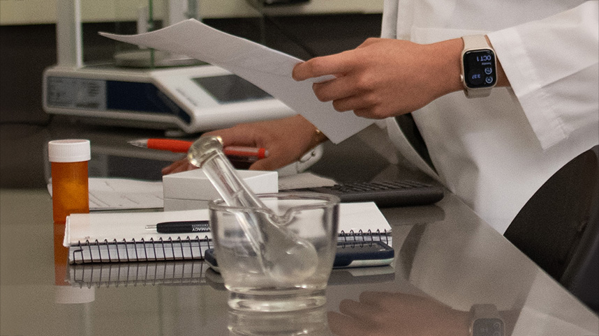 Pharmacy glassware on a lab table.