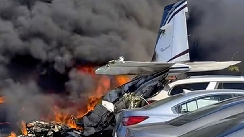 The White family's plane on fire after the crash.