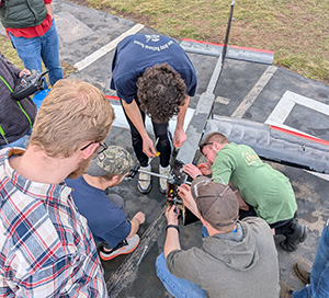 Sudents prepare their plane for a test flight.