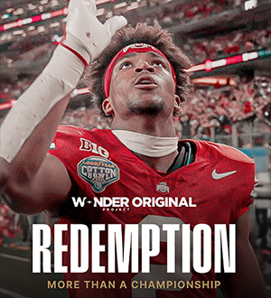 Ohio State University football player pointing upward.