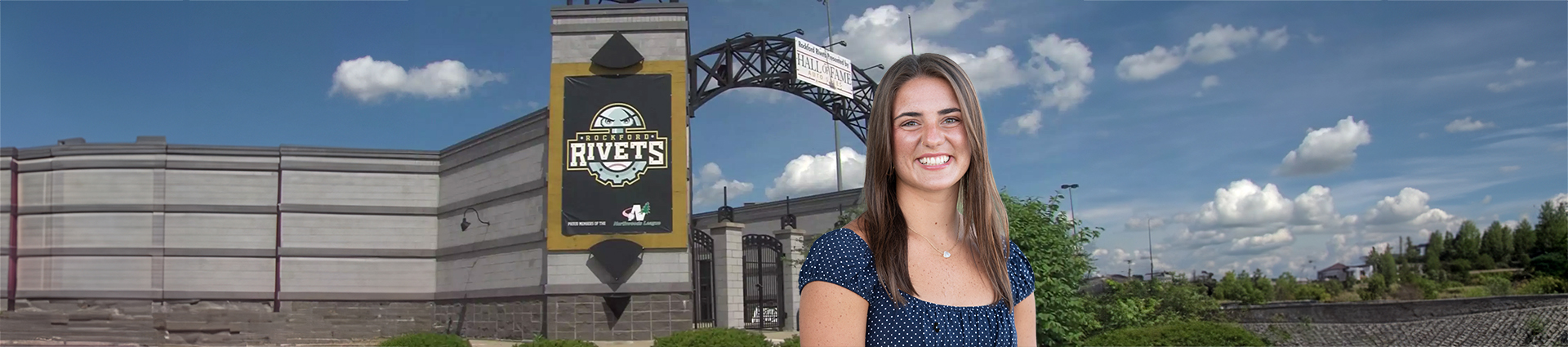Emily Tuttle in front of the Rockford Rivets Stadium.