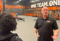 Mark Scharnberg talking to a player in the Iowa United gym.