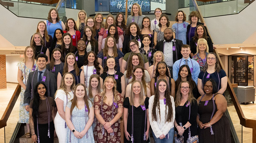 37 Cedarville University nursing students who were inducted into Sigma Theta Tau stand on the steps in the Stevens Student Center.