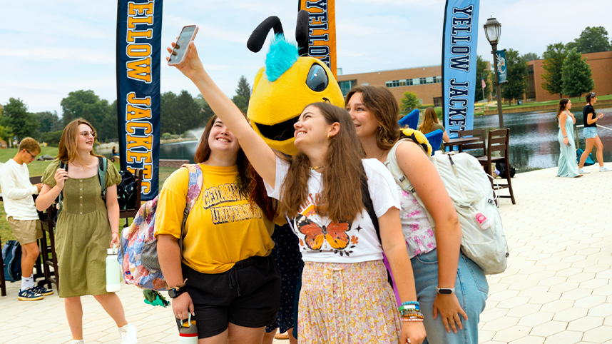 Female students taking a selfie beside the lake on the Cedarville University campus.