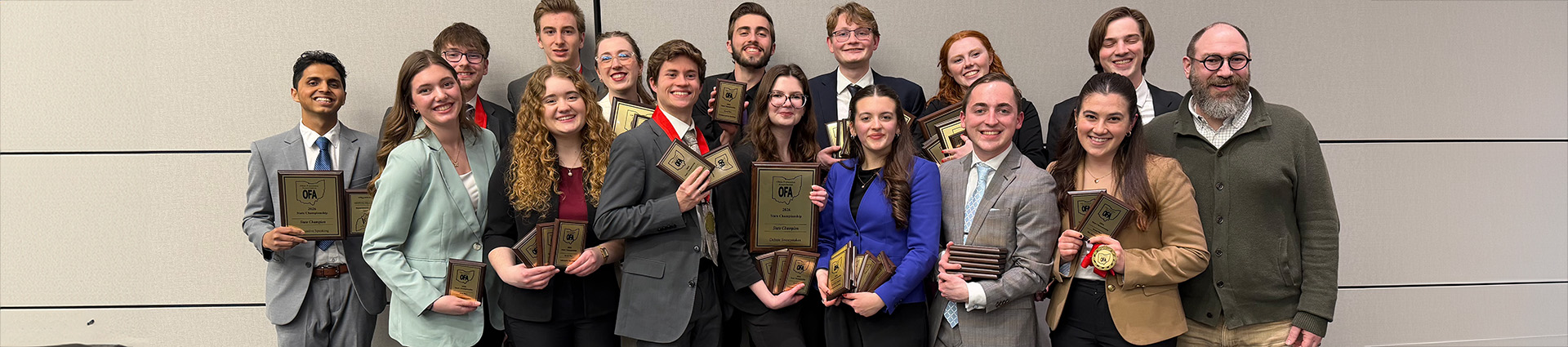 2026 Cedarville University state champion speech and debate team with their trophies.