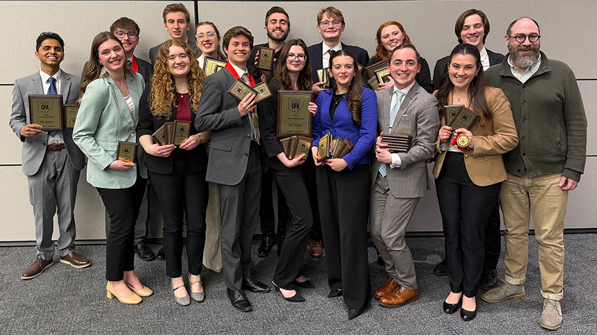 2026 Cedarville University state champion speech and debate team with their trophies.