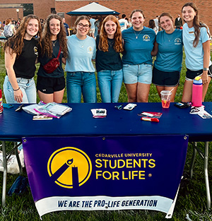 Six Cedarville University students stand behind students for life banner.
